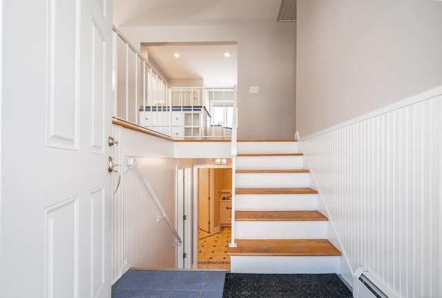 stairway with a baseboard heating unit