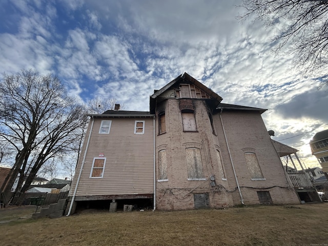 back of house with a lawn