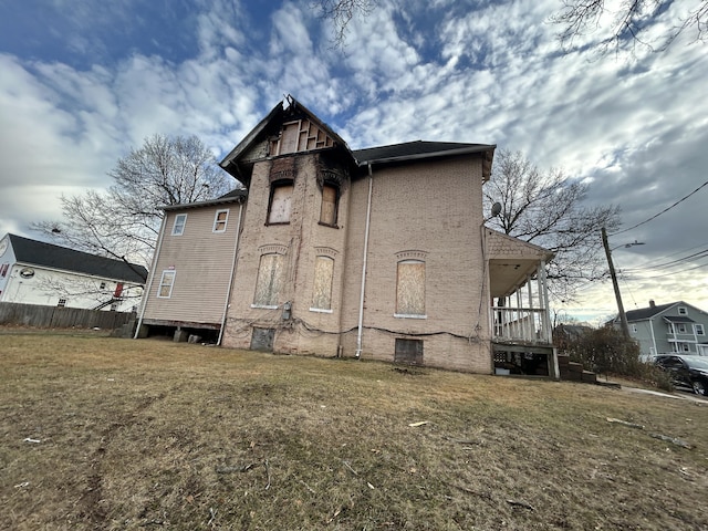 rear view of property featuring a yard