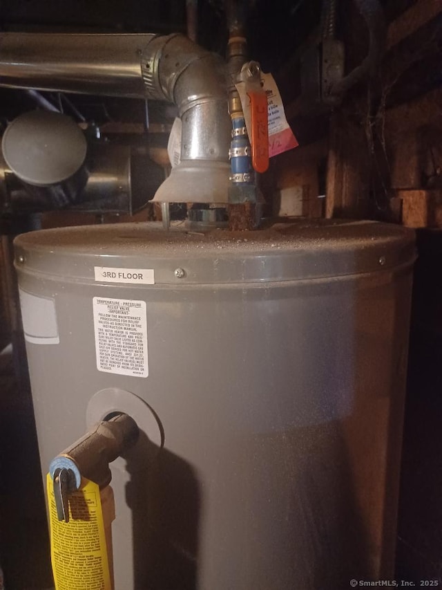 utility room featuring water heater