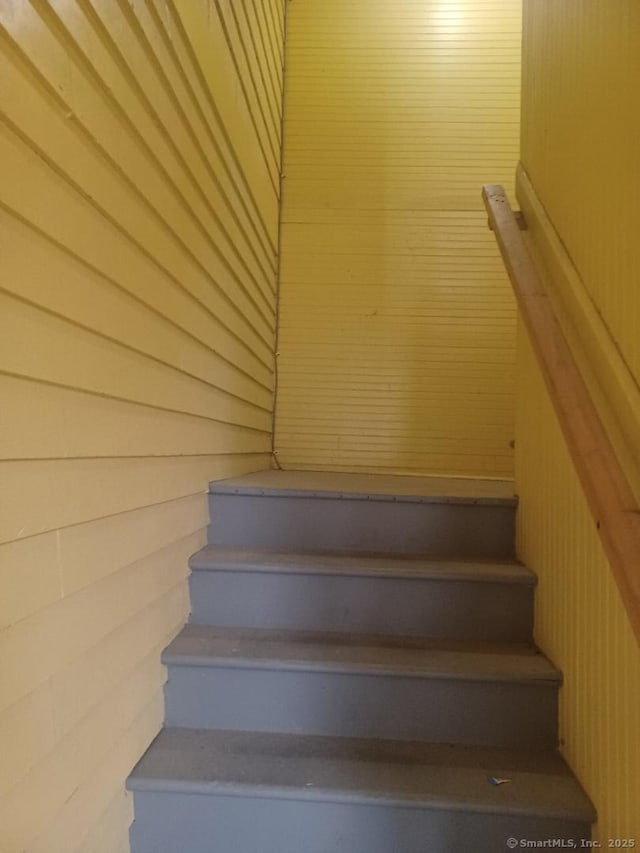 stairway with wooden walls