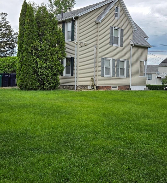 rear view of property with a lawn