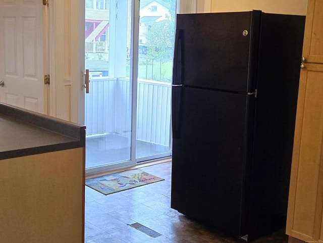 interior space with black refrigerator