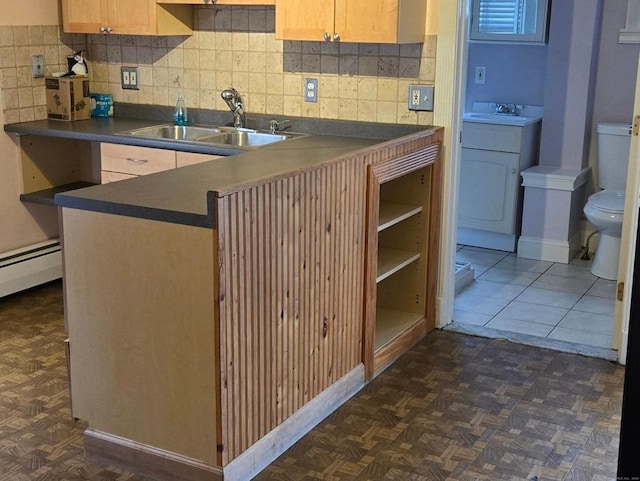 kitchen with sink, dark parquet floors, and light brown cabinetry