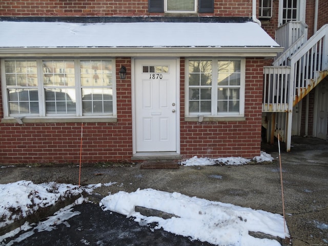 view of snow covered property entrance