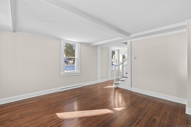 empty room featuring ornamental molding and dark hardwood / wood-style flooring