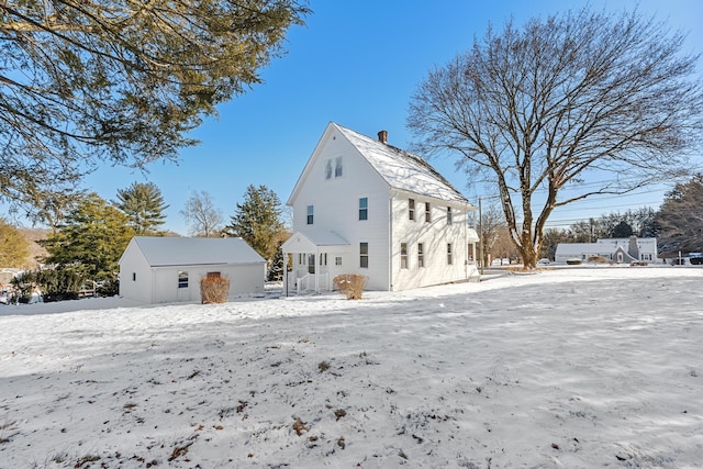 view of snow covered rear of property