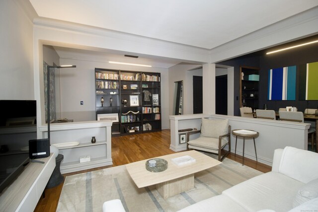 living room with hardwood / wood-style floors and ornamental molding