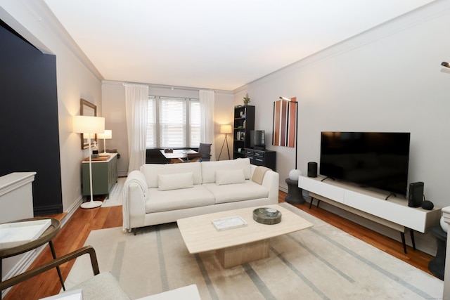 living room featuring crown molding and hardwood / wood-style floors