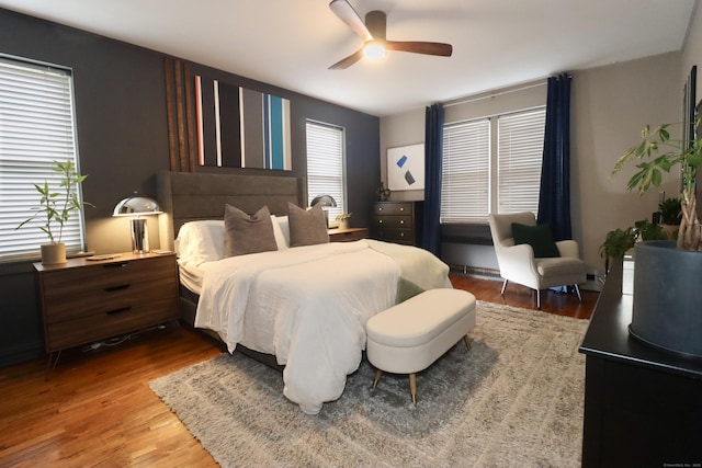 bedroom with hardwood / wood-style floors and ceiling fan