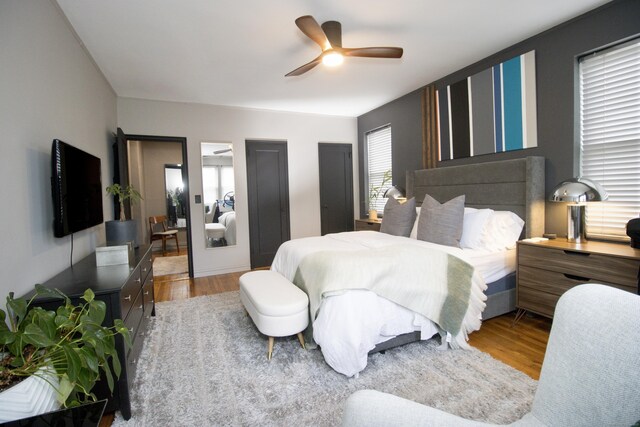 bedroom with light hardwood / wood-style floors and ceiling fan