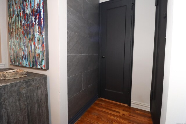 corridor with dark hardwood / wood-style floors