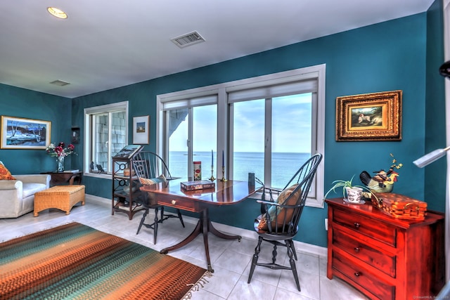 home office with a water view and light tile patterned floors