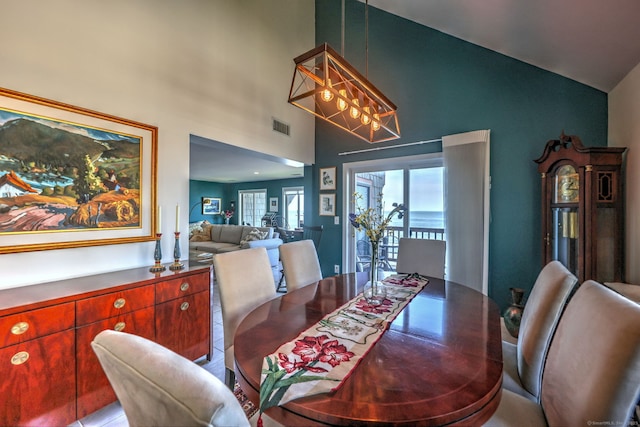 dining space with lofted ceiling and a notable chandelier