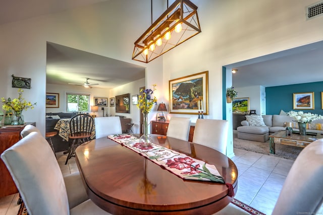 tiled dining area featuring vaulted ceiling and ceiling fan