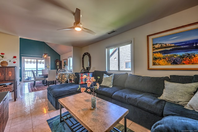 tiled living room with ceiling fan and vaulted ceiling