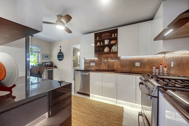 kitchen with sink, white cabinets, stainless steel appliances, and wall chimney exhaust hood