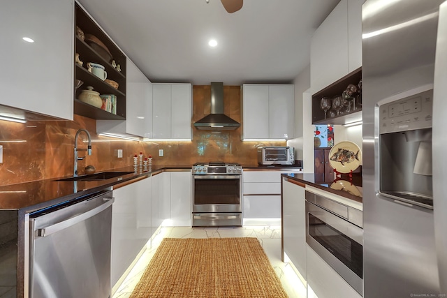 kitchen featuring sink, white cabinets, wall chimney range hood, and stainless steel appliances