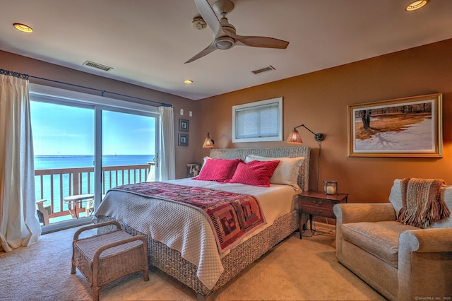 carpeted bedroom featuring access to exterior, a water view, and ceiling fan