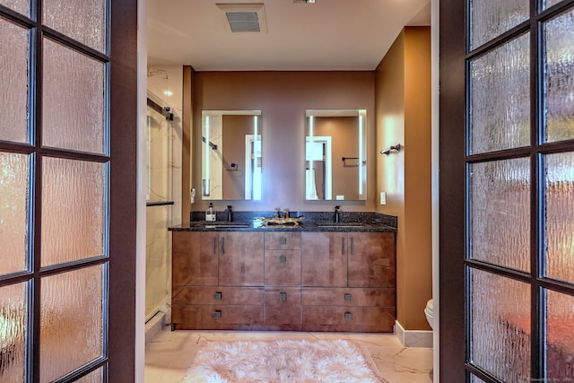 bathroom featuring vanity, toilet, and walk in shower