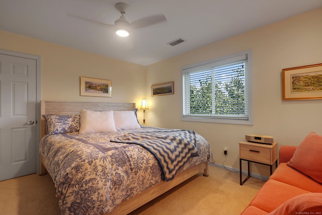 bedroom featuring light carpet and ceiling fan