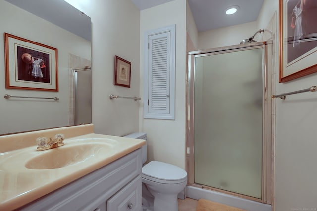 bathroom with a shower with door, toilet, and vanity