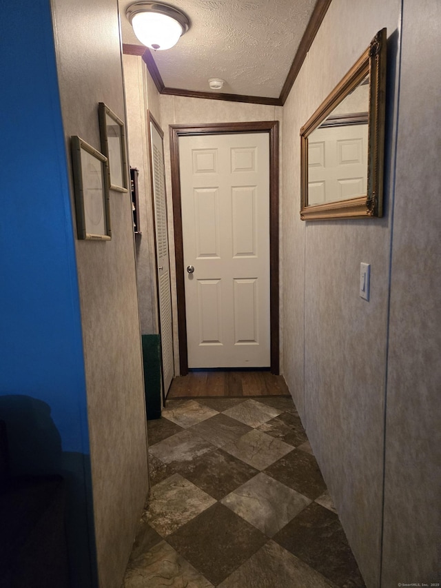 hall with crown molding and a textured ceiling