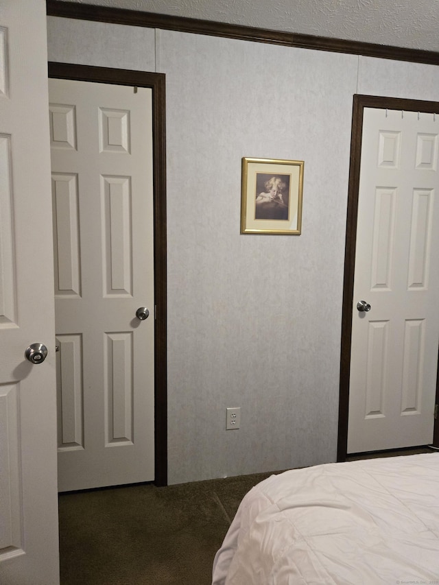 bedroom with crown molding and a textured ceiling