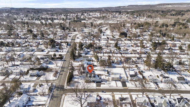 snowy aerial view featuring a residential view