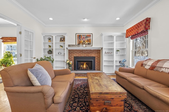 living room with ornamental molding, a fireplace, wood finished floors, and recessed lighting