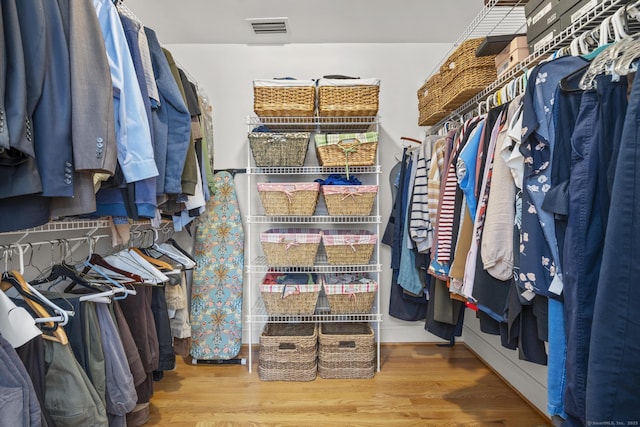 walk in closet with visible vents and wood finished floors