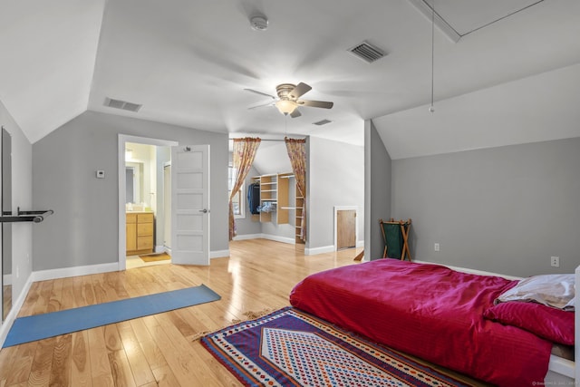 bedroom with lofted ceiling, hardwood / wood-style flooring, attic access, and visible vents