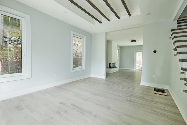 1240 Westport Tpke, Fairfield, CT 06824 - unfurnished room with light wood-style flooring, stairs, and a healthy amount of sunlight