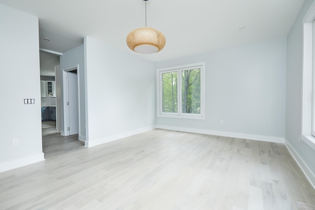 spare room with light hardwood / wood-style floors