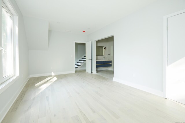1240 Westport Tpke, Fairfield, CT 06824 - spare room featuring stairs, baseboards, and light wood-type flooring