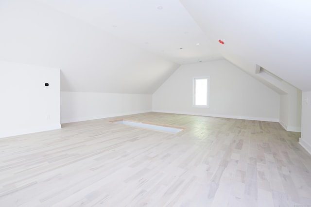 bonus room with lofted ceiling and light hardwood / wood-style floors