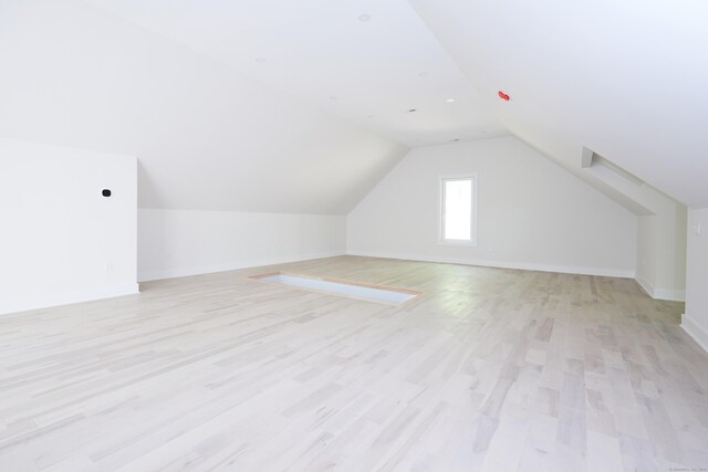 1240 Westport Tpke, Fairfield, CT 06824 - bonus room with baseboards, light wood-style flooring, and lofted ceiling