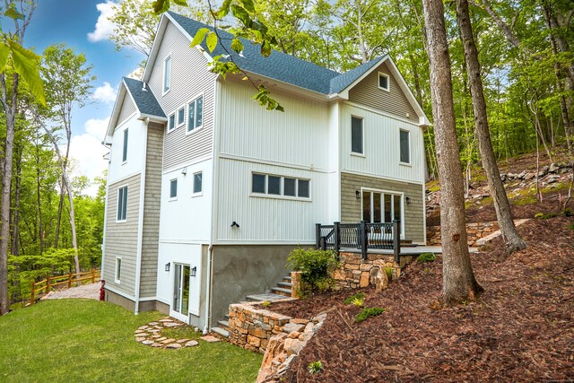 1240 Westport Tpke, Fairfield, CT 06824 - back of house featuring a shingled roof, fence, a yard, and a wooden deck