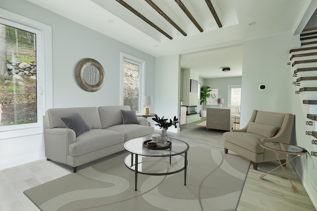 living room with light hardwood / wood-style flooring, beamed ceiling, and plenty of natural light