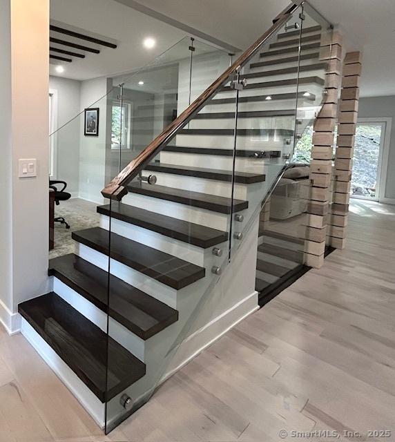 stairway with hardwood / wood-style flooring