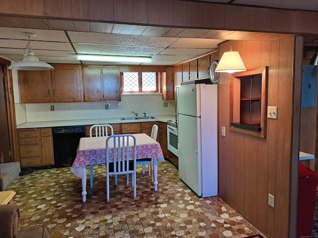 kitchen with wooden walls, black dishwasher, sink, hanging light fixtures, and white fridge