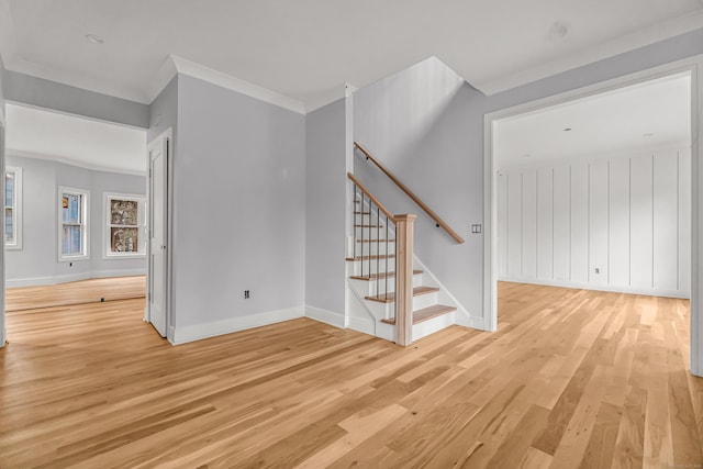 interior space with light wood-type flooring and ornamental molding