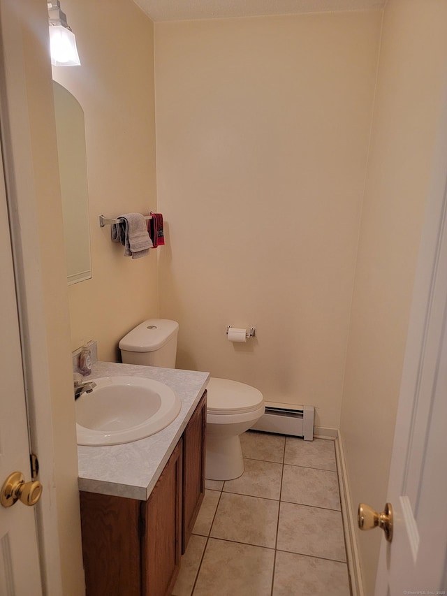 bathroom featuring baseboard heating, vanity, toilet, and tile patterned flooring