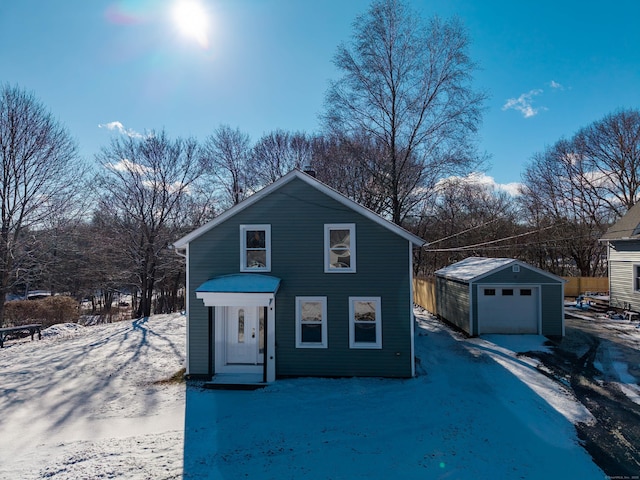 front of property with a garage and an outdoor structure