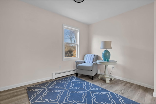 living area with hardwood / wood-style flooring and a baseboard radiator