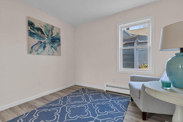 sitting room with hardwood / wood-style flooring and a baseboard radiator