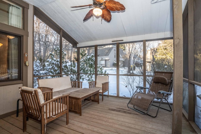 sunroom with lofted ceiling, a healthy amount of sunlight, and ceiling fan