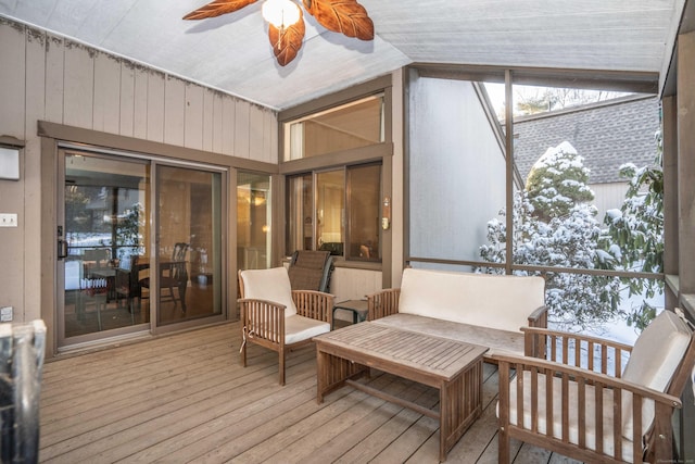 sunroom with ceiling fan and vaulted ceiling