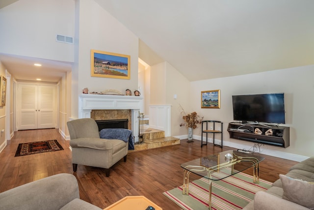 living room featuring high vaulted ceiling and hardwood / wood-style floors