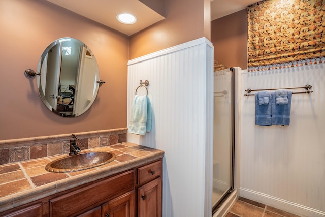 bathroom with walk in shower and vanity